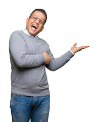 Middle age bussines arab man wearing glasses over isolated background Pointing to the side with hand and open palm, presenting ad smiling happy and confident