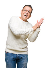 Fototapeta premium Middle age arab man wearing glasses over isolated background Clapping and applauding happy and joyful, smiling proud hands together