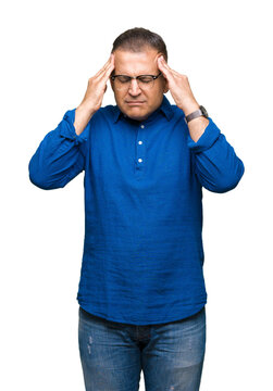 Middle age arab man wearing glasses over isolated background with hand on head for pain in head because stress. Suffering migraine.