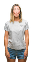 Obraz premium Young beautiful woman over isolated background making fish face with lips, crazy and comical gesture. Funny expression.