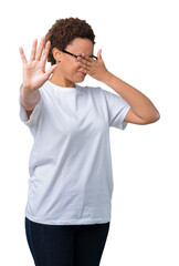 Beautiful young african american woman wearing glasses over isolated background covering eyes with hands and doing stop gesture with sad and fear expression. Embarrassed and negative concept.