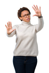 Fototapeta premium Young beautiful african american woman wearing glasses over isolated background Smiling doing frame using hands palms and fingers, camera perspective