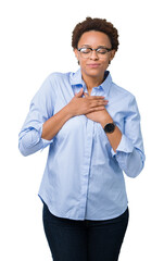 Young beautiful african american business woman over isolated background smiling with hands on chest with closed eyes and grateful gesture on face. Health concept.