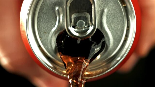 Cola pours from a tin can. High quality FullHD footage. Filmed is slow motion 1000 fps.
