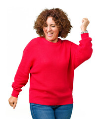 Beautiful middle ager senior woman red winter sweater over isolated background Dancing happy and cheerful, smiling moving casual and confident listening to music