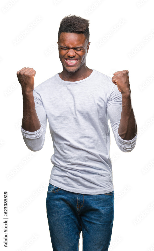 Wall mural Young african american man over isolated background very happy and excited doing winner gesture with arms raised, smiling and screaming for success. Celebration concept.