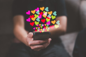 Social media concept. Hands with smartphone and like notification icon. Social networking, man using smartphone sending hearts icon on application internet network