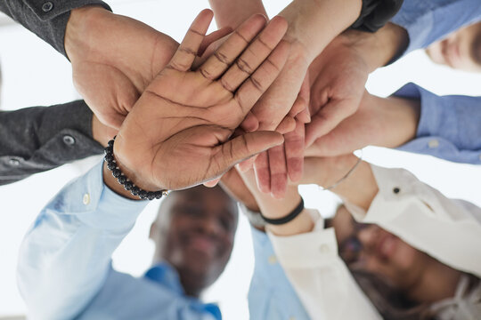 Hands of diversity men and women for corporate support, solidarity and mission or motivation
