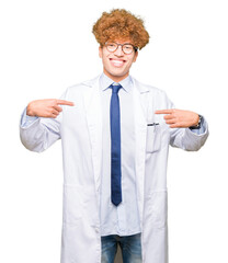 Young handsome scientist man wearing glasses looking confident with smile on face, pointing oneself with fingers proud and happy.