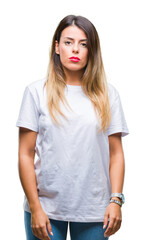 Fototapeta premium Young beautiful woman casual white t-shirt over isolated background with serious expression on face. Simple and natural looking at the camera.