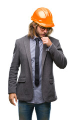Young handsome architec man with long hair wearing safety helmet over isolated background feeling unwell and coughing as symptom for cold or bronchitis. Healthcare concept.