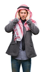 Young handsome arabian man with long hair wearing keffiyeh over isolated background with hand on head for pain in head because stress. Suffering migraine.