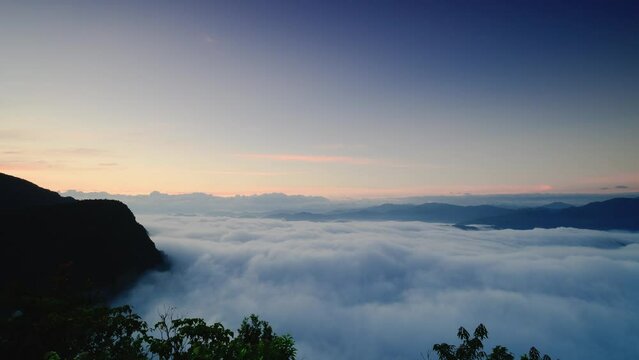Dynamic sea of clouds before sunrise. The camera zooms out. Awe-Inspiring Views of the White Cloud Sea on the Mountaintop. Taiwan