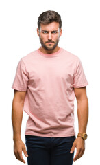 Young handsome man over isolated background skeptic and nervous, frowning upset because of problem. Negative person.
