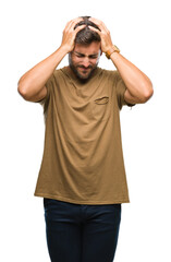 Fototapeta premium Young handsome man over isolated background suffering from headache desperate and stressed because pain and migraine. Hands on head.