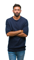 Obraz premium Adult hispanic man over isolated background skeptic and nervous, disapproving expression on face with crossed arms. Negative person.