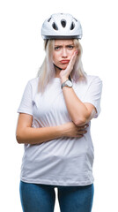 Young blonde woman wearing cyclist security helmet over isolated background thinking looking tired and bored with depression problems with crossed arms.