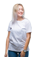 Fototapeta premium Young blonde woman over isolated background looking away to side with smile on face, natural expression. Laughing confident.