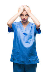 Fototapeta premium Young beautiful blonde doctor surgeon nurse woman over isolated background suffering from headache desperate and stressed because pain and migraine. Hands on head.