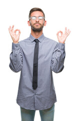 Young handsome business man over isolated background relax and smiling with eyes closed doing meditation gesture with fingers. Yoga concept.