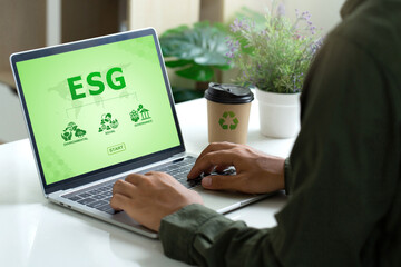 ESG environment social governance investment business concept. Men using laptops to analyze ESG on screen in business investment strategy concept. Environmental and Business Growth Together.