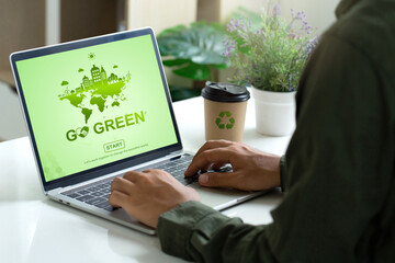 Go Green, Earth Day, Man using a laptop with GO GREEN environmen