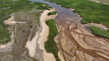 Looking down on marsh inlet at low tide at Cape Cod National Seashore, a family vacation destination by the Atlantic ocean in state of MASS in America