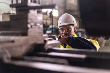 African worker Engineer working with cnc lathe machine for quality of product in factory with confident