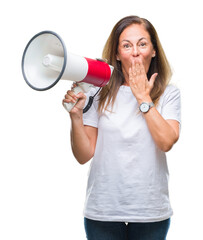 Middle age hispanic woman yelling through megaphone over isolated background cover mouth with hand shocked with shame for mistake, expression of fear, scared in silence, secret concept