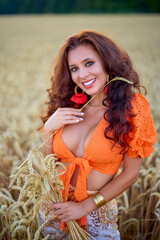 A beautiful woman with long hair posing in a field of wheat. conceptual fashion image.