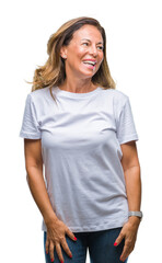 Obraz premium Middle age senior hispanic woman over isolated background looking away to side with smile on face, natural expression. Laughing confident.