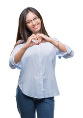 Young asian business woman wearing glasses over isolated background smiling in love showing heart symbol and shape with hands. Romantic concept.