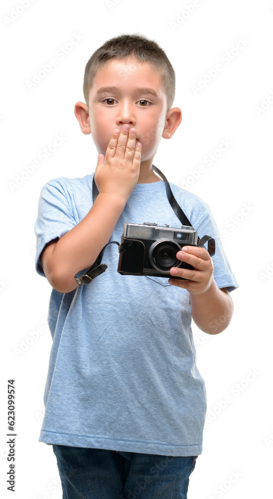 Canvas Prints Dark haired little child holding vintage camera cover mouth with hand shocked with shame for mistake, expression of fear, scared in silence, secret concept