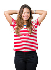 Obraz na płótnie Canvas Young beautiful brunette woman wearing stripes t-shirt over isolated background Relaxing and stretching with arms and hands behind head and neck, smiling happy