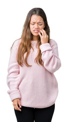 Young beautiful brunette woman wearing pink winter sweater over isolated background touching mouth with hand with painful expression because of toothache or dental illness on teeth. Dentist concept.