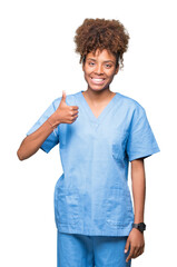 Young african american doctor woman over isolated background doing happy thumbs up gesture with hand. Approving expression looking at the camera with showing success.