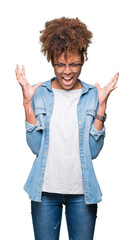 Beautiful young african american woman wearing glasses over isolated background celebrating mad and crazy for success with arms raised and closed eyes screaming excited. Winner concept