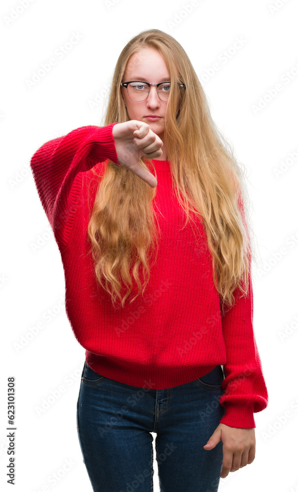 Poster blonde teenager woman wearing red sweater looking unhappy and angry showing rejection and negative w