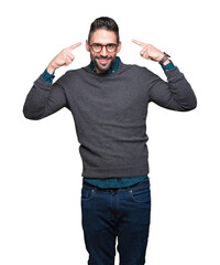 Young handsome man wearing glasses over isolated background Smiling pointing to head with both hands finger, great idea or thought, good memory