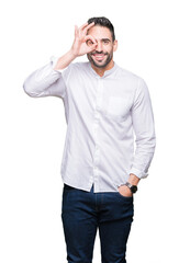 Fototapeta premium Young business man over isolated background doing ok gesture with hand smiling, eye looking through fingers with happy face.