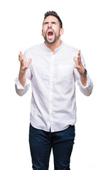 Young business man over isolated background crazy and mad shouting and yelling with aggressive expression and arms raised. Frustration concept.