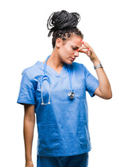 Young braided hair african american girl professional surgeon over isolated background tired rubbing nose and eyes feeling fatigue and headache. Stress and frustration concept.