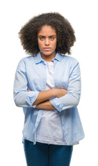 Young afro american woman over isolated background skeptic and nervous, disapproving expression on face with crossed arms. Negative person.