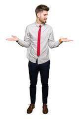 Young handsome business man Smiling showing both hands open palms, presenting and advertising comparison and balance