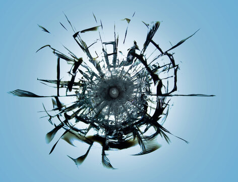 The effect of cracks on the glass from the impact of a bullet from a weapon. Armored glass with cracks from a shot on a blue background.