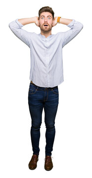 Young handsome man Crazy and scared with hands on head, afraid and surprised of shock with open mouth