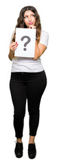 Obraz premium Young adult woman holding paper with question mark serious face thinking about question, very confused idea