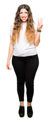 Obraz premium Young beautiful woman wearing casual white t-shirt showing and pointing up with fingers number three while smiling confident and happy.