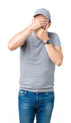 Handsome middle age hoary senior man wearing sport cap over isolated background Covering eyes and mouth with hands, surprised and shocked. Hiding emotion