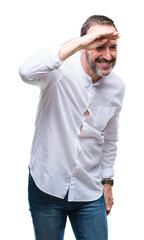 Fototapeta premium Middle age hoary senior man over isolated background very happy and smiling looking far away with hand over head. Searching concept.